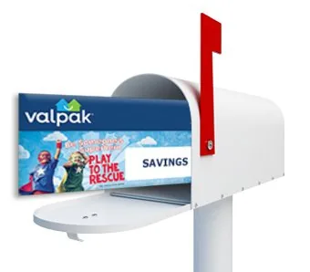 The Valpak blue envelope arriving in a mailbox.