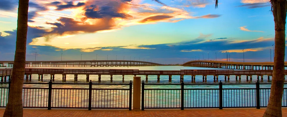 A bay bridge and fishing pier in Southwest Florida at dusk.